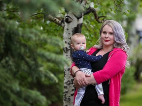 Renee Edison, holding her eight-month-old daughter Reya, is one of hundreds of Sage Hill residents facing potential legal action over unpaid fees. Edison says she never received an annual invoice or any warnings from the residents' association.