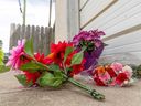 Flowers are left at the scene where an 86-year-old woman was attacked and killed by three dogs in northwest Calgary on Sunday, June 5, 2022. 