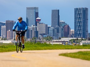 A break in a day of showers was a chance for Calgarians to enjoy the sun and the downtown skyline along a bike path in Lynnwood on Thursday, June 23, 2022. 
Gavin Young/Postmedia