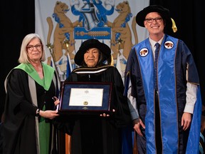 At a convocation ceremony at Mount Royal University on June 1, Indigenous elder and adviser Doreen Spence, centre, received an honorary doctor of laws. She is pictured with Elizabeth Evans, interim provost, MRU, at left, and Tim Rahilly, president and vice-chancellor, MRU, at right.  SUPPLIED