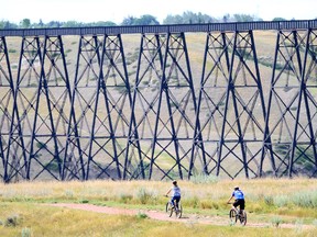 Biking in a coulee along the High Level Bridge in Lethbridge, the highest and longest trestle bridge in the world.   ANDREW PENNER