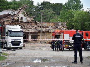 FILE PHOTO: Firefighters work in an area affected by a military attack, as Russia's invasion of Ukraine continues, in Zolochiv, Lviv region, Ukraine, June 14, 2022.