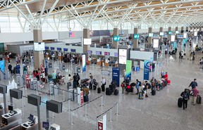 Passengers check in for flights at Calgary International Airport on Tuesday.