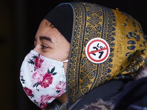 A demonstrator protests Bill 21 before a Quebec Superior Court hearing in Montreal on Nov. 2, 2020.