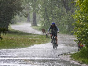 A cyclist braves the downpour along the Bow River pathway in Inglewood as a thunderstorm hit the north part of the city on Sunday, June 12, 2022. Calgary and Southern Alberta can expect heavy rain Monday and Tuesday.
Gavin Young/Postmedia
