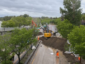 City of Calgary crews are constructing an earth berm across Memorial Drive as flood protection on Tuesday, June 14, 2022.
