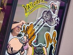 Valerie Nimchuk paints Calgary Stampede themed window art at the Renovation Room in Calgary on Wednesday, June 15, 2022. 
Gavin Young/Postmedia