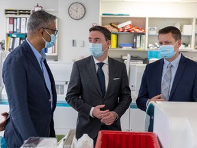 Alberta Minister of Health, Jason Copping, tours Alberta Precision Laboratories in Calgary on Thursday, June 2, 2022 with Dr. Dylan Pillai, Southern Sector Medical Director, Alberta Precision Laboratories, (left) and Jason Pincock, President and CEO, Dynalife Medical Labs.