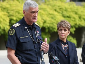 Calgary Mayor Jyoti Gondek listens as Calgary Fire Chief Steve Dongworth calls for the province to reinstate the previous integrated dispatch of EMS services in Calgary on Thursday, June 9, 2022.