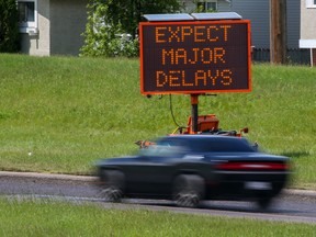 Signs on McKnight Boulevard between 52nd and 68th Streets NE alert motorists of delays during nighttime paving on Thursday, June 23, 2022. The City of Calgary's 2022 paving program began this week.