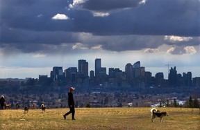 Storm clouds move over walkers in Edworthy Park.  Gavin Young/Post Media