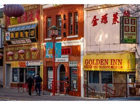 Colourful store fronts in Calgary’s Chinatown are lit by reflected morning light.Gavin Young/Postmedia