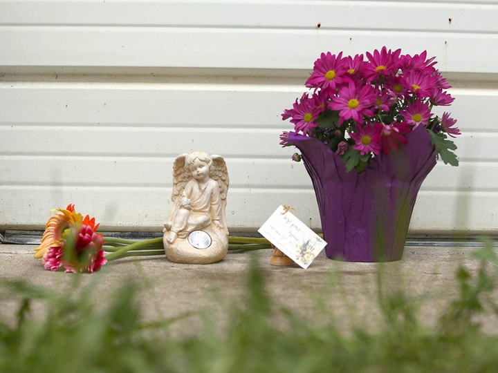  Flowers are displayed at the scene of a fatal dog attack in northwest Calgary last Sunday.