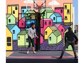 Benjamin McCullough, left, laughs as he plays basketball with Russ Cross in Calgary’s East Village. Gavin Young/Postmedia