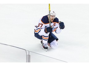 Edmonton Oilers center Connor McDavid (97) celebrates his goal against the Calgary Flames during the first overtime period in game five of the second round of the 2022 Stanley Cup Playoffs at Scotiabank Saddledome. Sergei Belski/USA TODAY Sports.