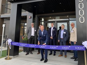 Tim Logel, president and CEO of Logel Homes, cuts the ribbon at the Seton West grand opening in Seton, Calgary, on June 2, 2022. With him, from left, are: 
Trent Edwards, president, Canada Land and Housing Development, Brookfield Residential Properties; Brayden Logel, vice-president, Logel Homes; Kevin Logel, senior site superintendent, Logel Homes; Elton Ma, director, Calgary Commercial, Land and Housing Development, Brookfield Residential Properties; and Ryan Ockey, president and CEO, Cardel Homes.
