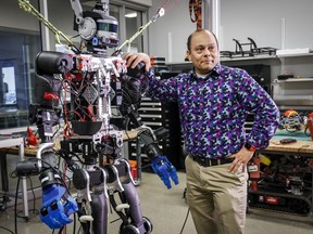 Schulich School of Engineering professor Alejandro Ramirez-Serrano leans on one of his robots at the University of Calgary's unmanned vehicles robotarium lab in Calgary on Tuesday, June 14, 2022.
