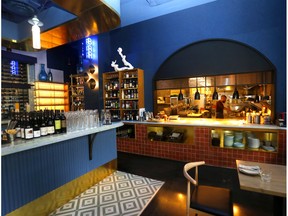 Peek into the kitchen while admiring the well-stocked bar at Kama. Darren Makowichuk/Postmedia