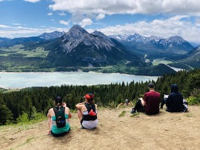 Hikers at the Barrier Lake overlook in Kananaskis Country in June 2020. In 2021, the Alberta government imposed a  per day fee on vehicles, or a  annual pass, for public access to K-Country.