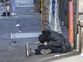 A person in an alleyway in Vancouver's Downtown Eastside is shown in this photo. Over 27,000 people died across the country from toxic street drugs between 2016 and September 2021.