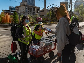 Volunteers with BeTheChangeYYC hand out water during an outreach shift in downtown Calgary.