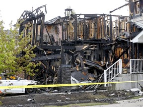 Calgary fire investigate a fire at Evansmeade Common N.W. that destroyed multiple homes in the community of Evanston in Calgary on Saturday, June 4, 2022.