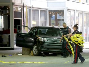 Calgary police investigate a serious single vehicle crash on 3str. and 7ave. S.W. after the women passenger was pinned underneath the vehicle and the male driver also sustaining serious injuries as well in Calgary on Tuesday, May 31, 2022.