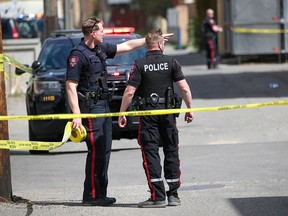 FILE PHOTO: Calgary police investigate a shooting in an alley in the 1000 block of 17th Avenue S.W. on May 23, 2022.