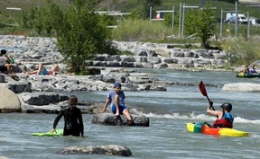 People are seen enjoying a hot day along the Bow River in Harvie Passage.  postmedia files