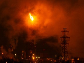 A flare from the Suncor Energy Edmonton Refinery illuminates the sky in Strathcona County, on Friday, Jan. 21, 2022.
