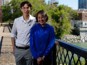 Keegan Buffalo, Grade 12 student from Tsuut'ina Nation who attends Saint Mary’s High School, poses for a photo with his mother Billie-Dee Buffalo on a bridge on Elbow River on Tuesday, July 5, 2022.