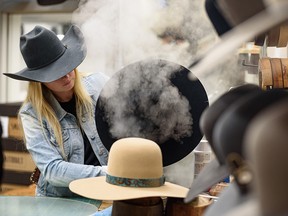 Sarah Dunlop shapes a hat for a customer at Smithbilt Hats.