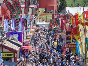 People enjoy a hot and sunny afternoon at Stampede grounds on Friday, July 15, 2022.
