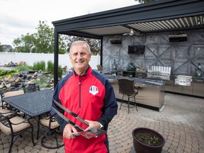 Alan Stiff, rain or snow, spends most of the year enjoying his outdoor kitchen, built by Year Round Landscaping.