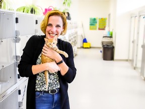 Calgary Humane Society executive director Carrie Fritz with one of the shelter’s residents in the new adoption space. The humane society is holding a 100th anniversary celebration on Saturday, Aug. 6.   SUPPLIED