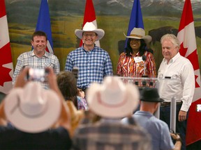 Conservative leadership contestants (L-R) Roman Baber, Pierre Poilievre, Leslyn Lewis and Jean Charest pose after each giving a short speech during the Conservative Party of Canada Stampede BBQ event held at Heritage Park in Calgary on Saturday, July 9, 2022.