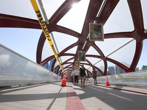 Damage is shown at the Peace Bridge near downtown Calgary on Sunday, July 24, 2022. Column writer George Brookman suggests night-time security is an easy solution to stopping vandalism and those costs could be offset by the money currently spent on repairs each year.