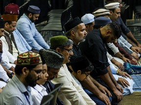 Men praying at the 38th annual Jalsa Salana Muslim convention in Calgary on Saturday, July 30, 2022.