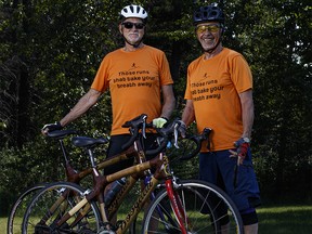 Cyclists Ross Weaver (left) and Bernie Potvin (right), pose for a photo with their bamboo bikes  in Calgary on Sunday, July 31, 2022. Weaver and Potvin are using bamboo bikes to cycle across Canada to raise money to manufacture bamboo wheelchairs to be sent to Uganda.