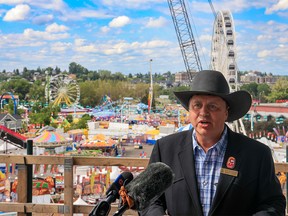 Calgary Stampede President & Chairman of the Board, Steve McDonough speaks about this year’s Stampede from the BMO Centre expansion construction site with the midway as a backdrop on Sunday, July 17, 2022.