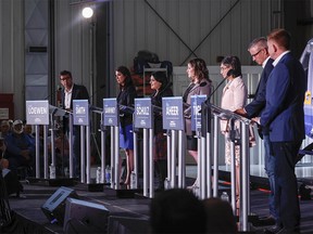Candidates, left to right, Todd Loewen, Danielle Smith, Rajan Sawhney, Rebecca Schulz, Leela Aheer, Travis Toews, and Brian Jean, attend the United Conservative Party of Alberta leadership candidate’s debate in Medicine Hat, Alta., Wednesday, July 27, 2022.