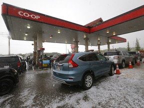 Cars take cover at a Co-op gas station in Rocky Ridge as heavy hail from a tornado-warned storm passed through Calgary on Thursday, July 7, 2022.