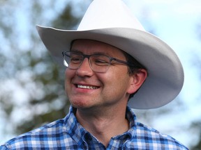 Pierre Poilievre chats with partygoers during the Conservative Party of Canada Stampede BBQ event held at Heritage Park in Calgary on Saturday, July 9, 2022.