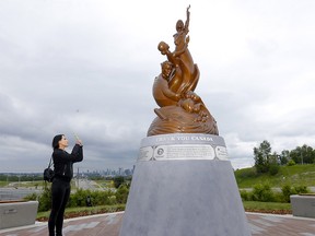 Michelle Vu takes pictures of a new monument unveiled at a southeast Calgary park at the entrance to the city’s International Avenue in the southeast. The monument honours the Vietnamese people who lost their lives escaping Vietnam after the fall of Saigon in 1975. Photo taken in Calgary on Sunday, July 3, 2022.