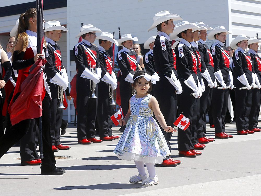 People take part in a Canada Day citizenship ceremony before the