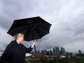 Joyceann Runions take in the view of the city from Scotsman Hill as the city has been receiving more rain than usual in Calgary on Monday, July 4, 2022.