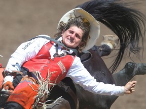 Cowboy Rocker Steiner of Weatherford, Texas,	on Little Rotten during the bareback event at the Calgary Stampede rodeo on Tuesday.