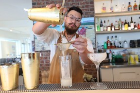 Bartender Jimmy Nguyen mixes the Lunch Lady, left and Carrot Goggles cocktails. Gavin Young/Postmedia