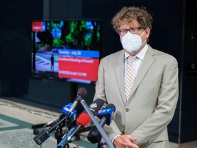 Calgary City Councillor Gian-Carlo Carra answers media questions outside council chambers on Tuesday, July 26, 2022.