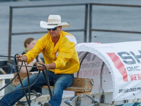 Chad Fike hits the finish line at the Cowboys Rangeland Derby at the Calgary Stampede on Monday,